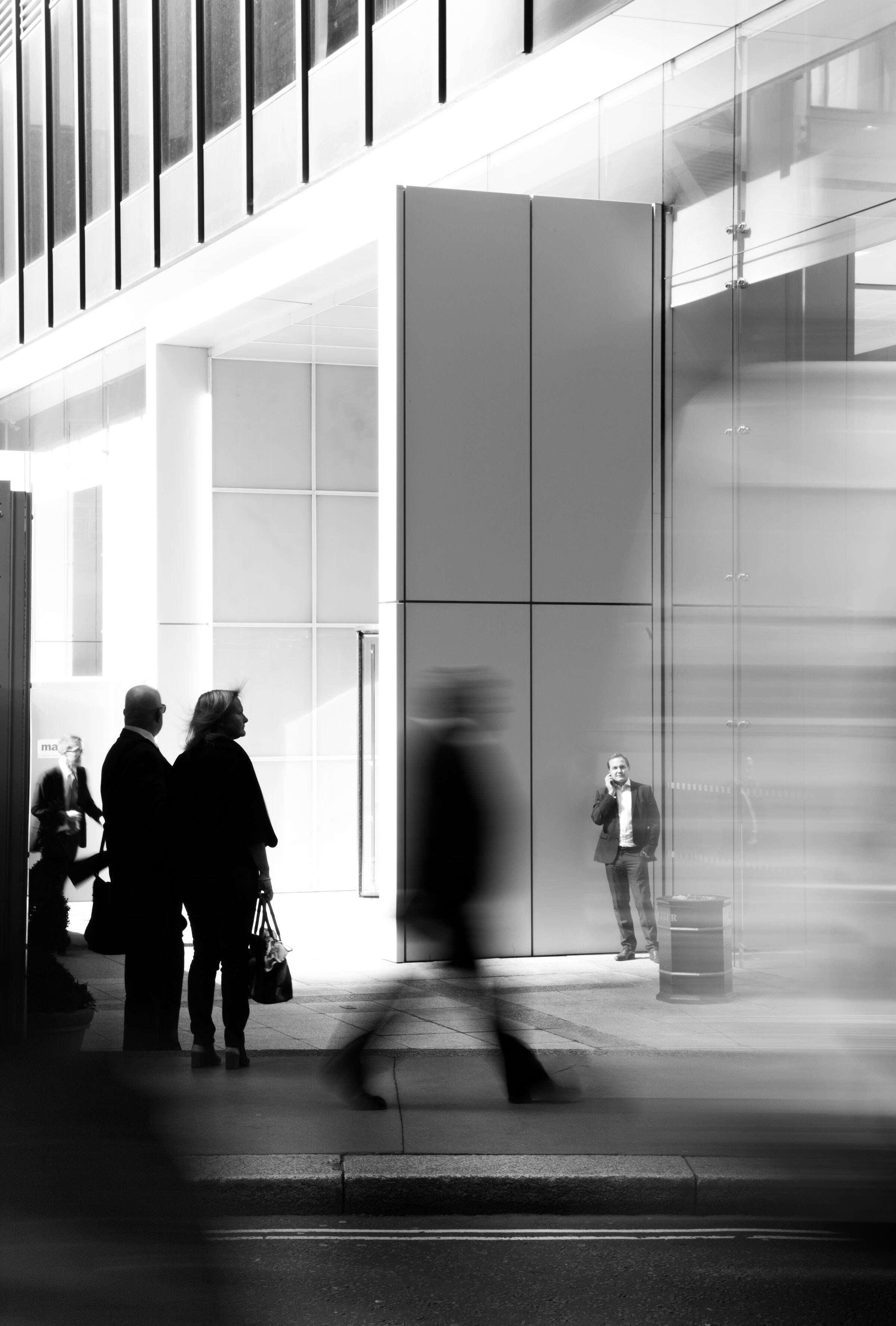 Man on a phone doing a business call in an urban environment